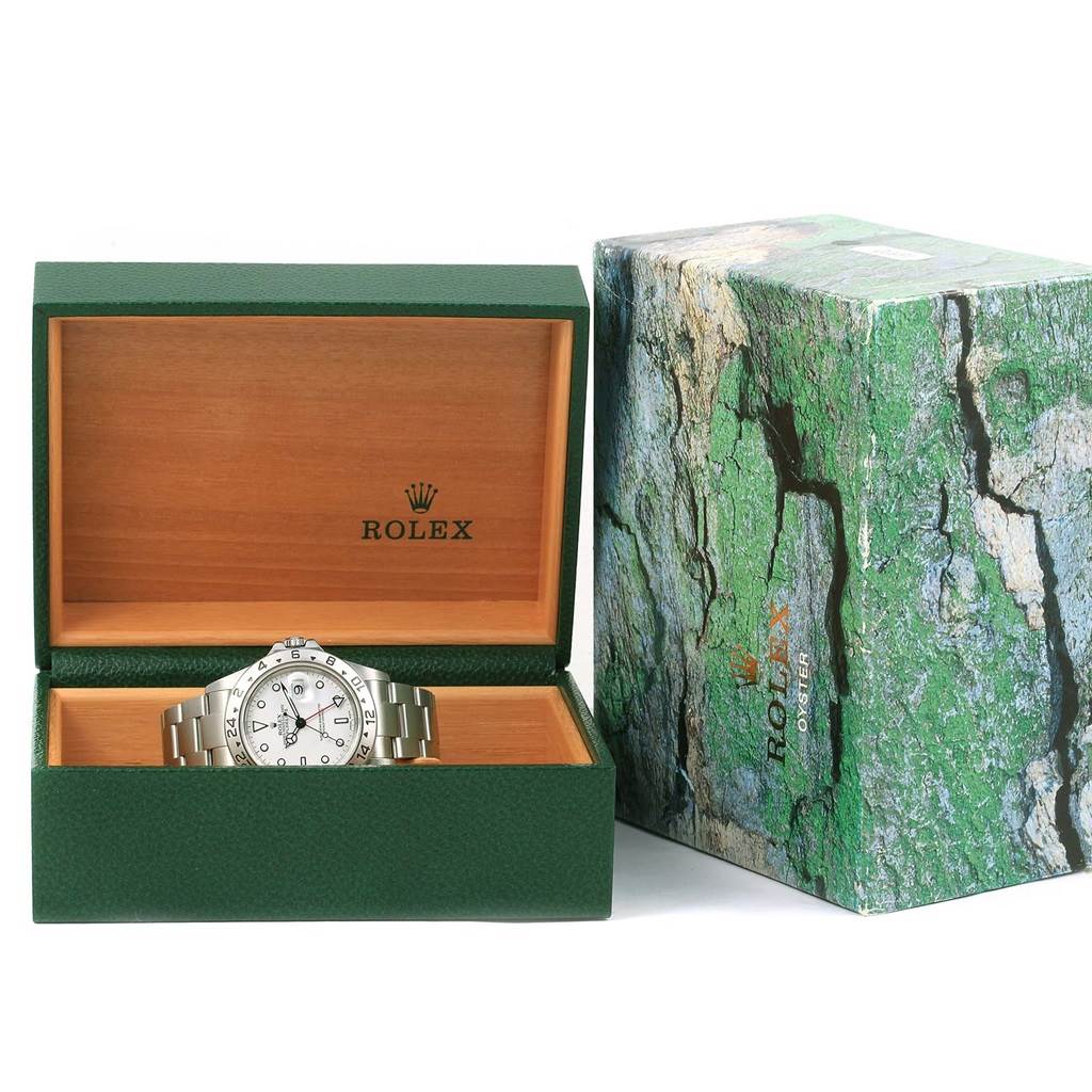 The image shows a Rolex Explorer 16570 Men's Stainless Steel White Dial 16570 Men's Stainless Steel White Dial watch front-on inside an open green and wooden Rolex box, next to a green Rolex outer box.