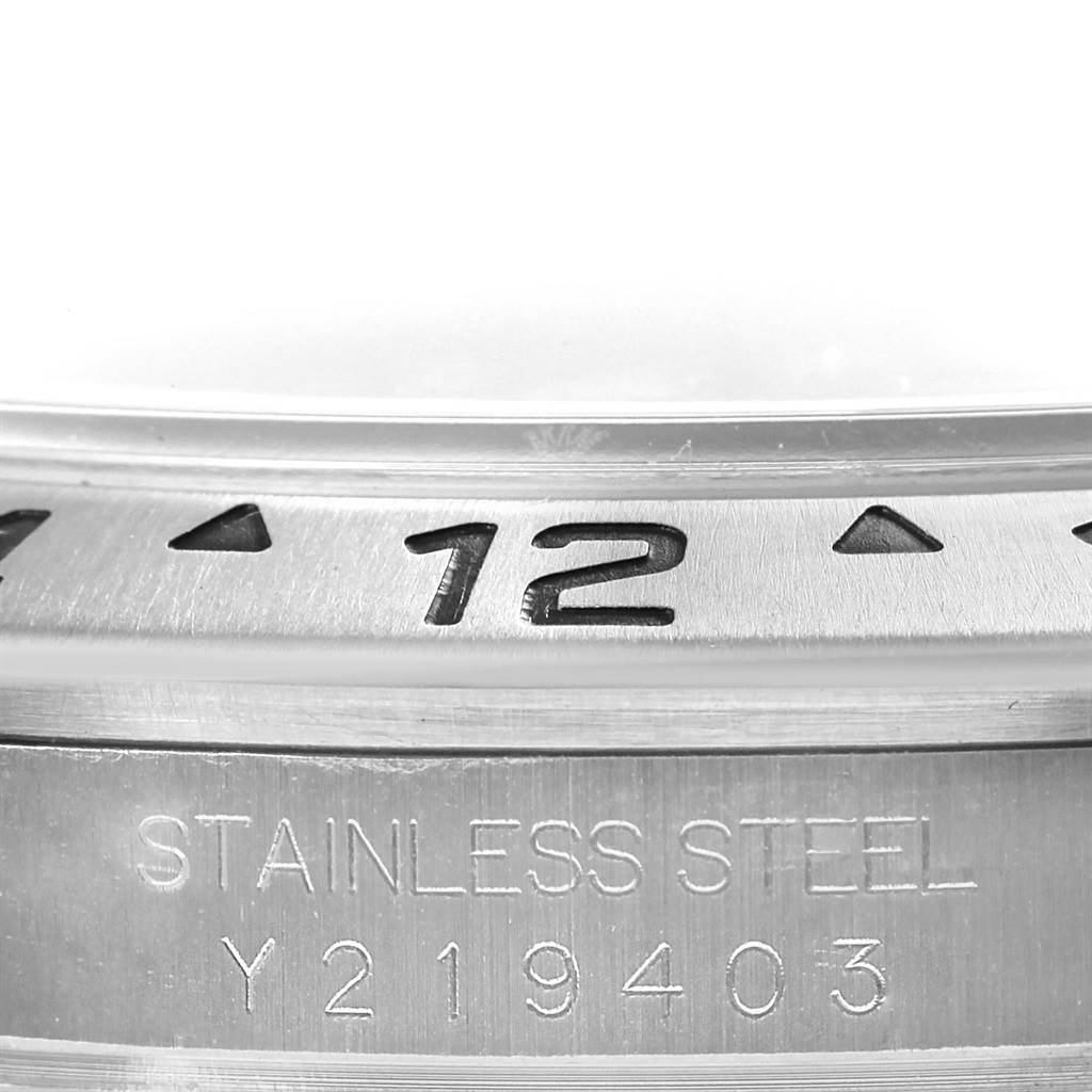 This close-up image shows the bezel and the stainless steel case with engravings of the Rolex Explorer 16570 Men's Stainless Steel White Dial 16570 Men's Stainless Steel White Dial model watch.