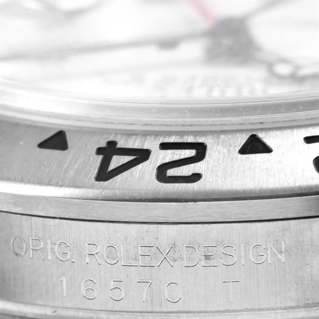 The image shows a close-up of the bezel and engraved text on a Rolex Explorer 16570 Men's Stainless Steel White Dial 16570 Men's Stainless Steel White Dial watch.