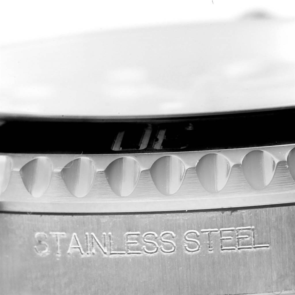 The image shows a close-up of the stainless steel bezel and case of a Rolex Explorer 114060 Men's Stainless Steel Black Dial 114060 Men's Stainless Steel Black Dial watch.