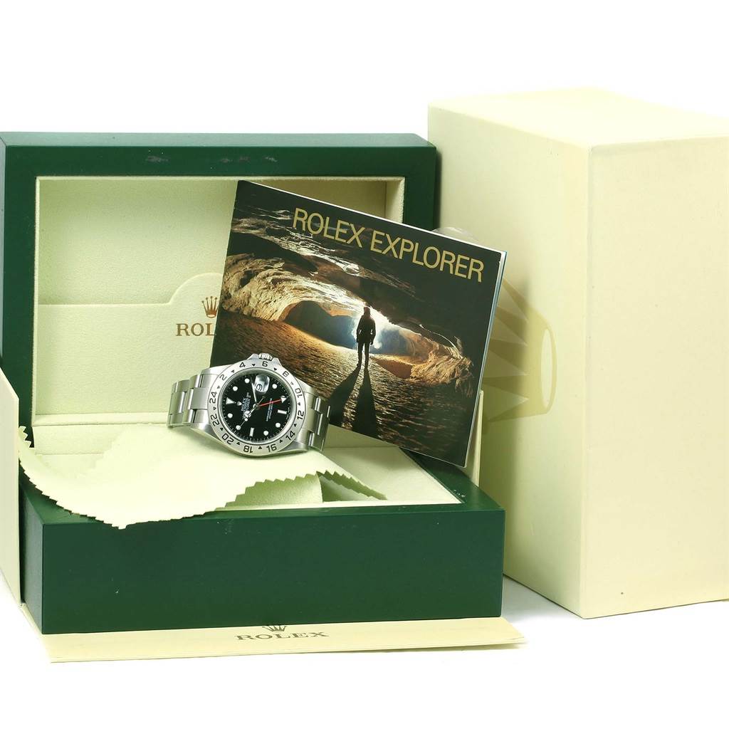 The image shows a Rolex Explorer 16570 Men's Stainless Steel Black Dial 16570 Men's Stainless Steel Black Dial watch with its box, booklet, and cleaning cloth from a slight top-front angle.