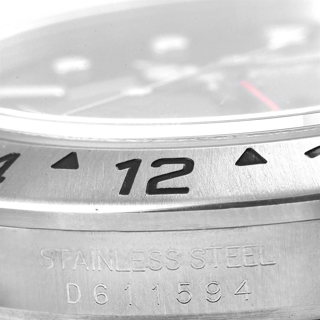 The image shows a close-up of the bezel and part of the case of a Rolex Explorer 16570 Men's Stainless Steel Black Dial 16570 Men's Stainless Steel Black Dial watch.