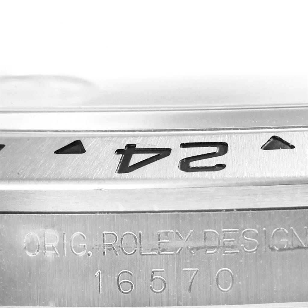 This close-up image shows the bezel and part of the case back of a Rolex Explorer 16570 Men's Stainless Steel White Dial 16570 Men's Stainless Steel White Dial model 16570.