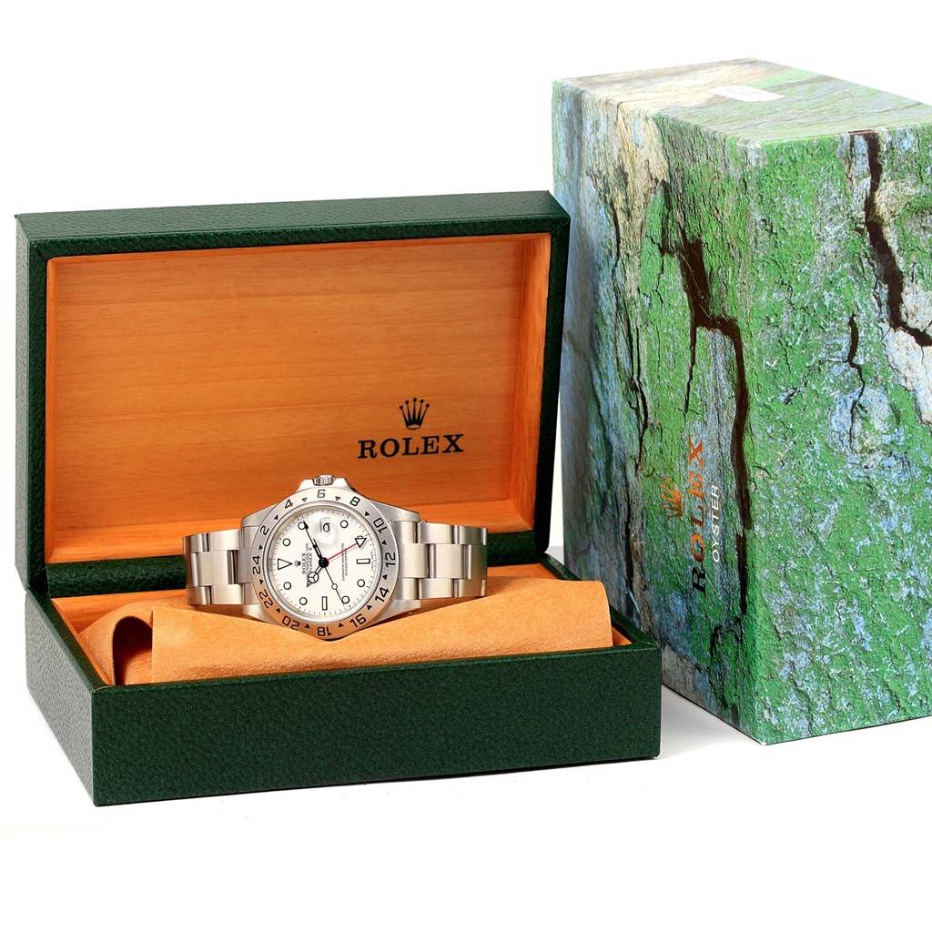 The Rolex Explorer 16570 Men's Stainless Steel White Dial 16570 Men's Stainless Steel White Dial watch is shown at a front angle, placed inside its branded box with the outer box nearby.