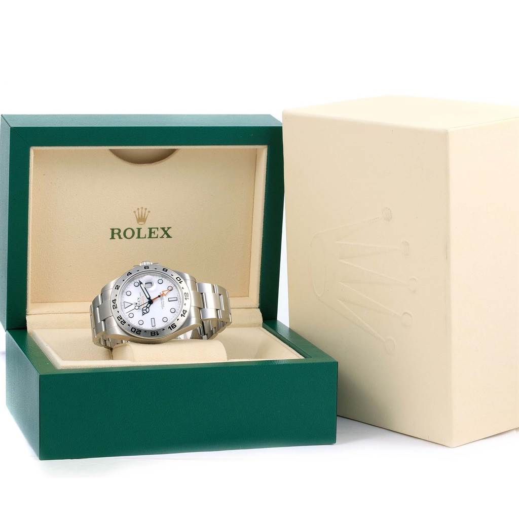 The image shows a Rolex Explorer 216570 Men's Stainless Steel White Dial 216570 Men's Stainless Steel White Dial model watch placed inside an open green and cream-colored Rolex box, with an additional cream-colored box beside it.