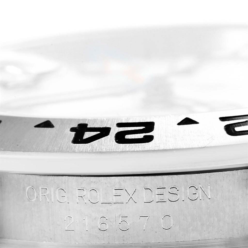 This image of a Rolex Explorer 216570 Men's Stainless Steel White Dial 216570 Men's Stainless Steel White Dial watch shows a close-up view of the bezel and engraved model number.