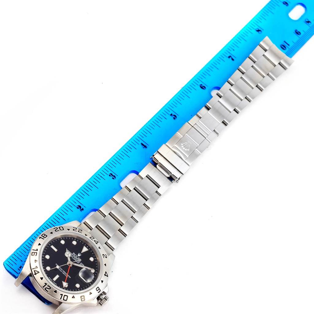 The image shows a Rolex Explorer 16570 Men's Stainless Steel Black Dial 16570 Men's Stainless Steel Black Dial watch and band laid flat next to a blue ruler for measurement.