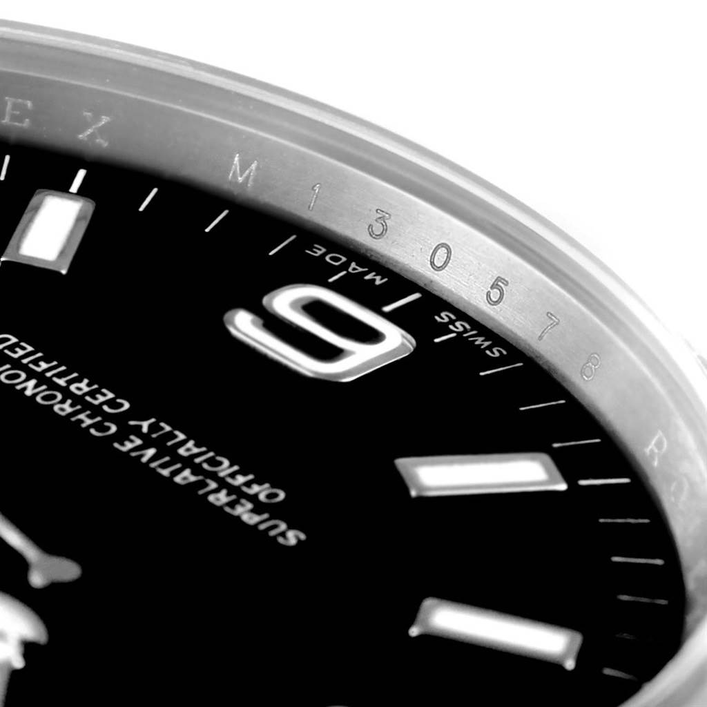 This close-up shot of the Rolex Explorer 114270 Men's Stainless Steel Black Dial 114270 Men's Stainless Steel Black Dial watch displays the "6" numeral, part of the minute markers, and the "Swiss Made" text.