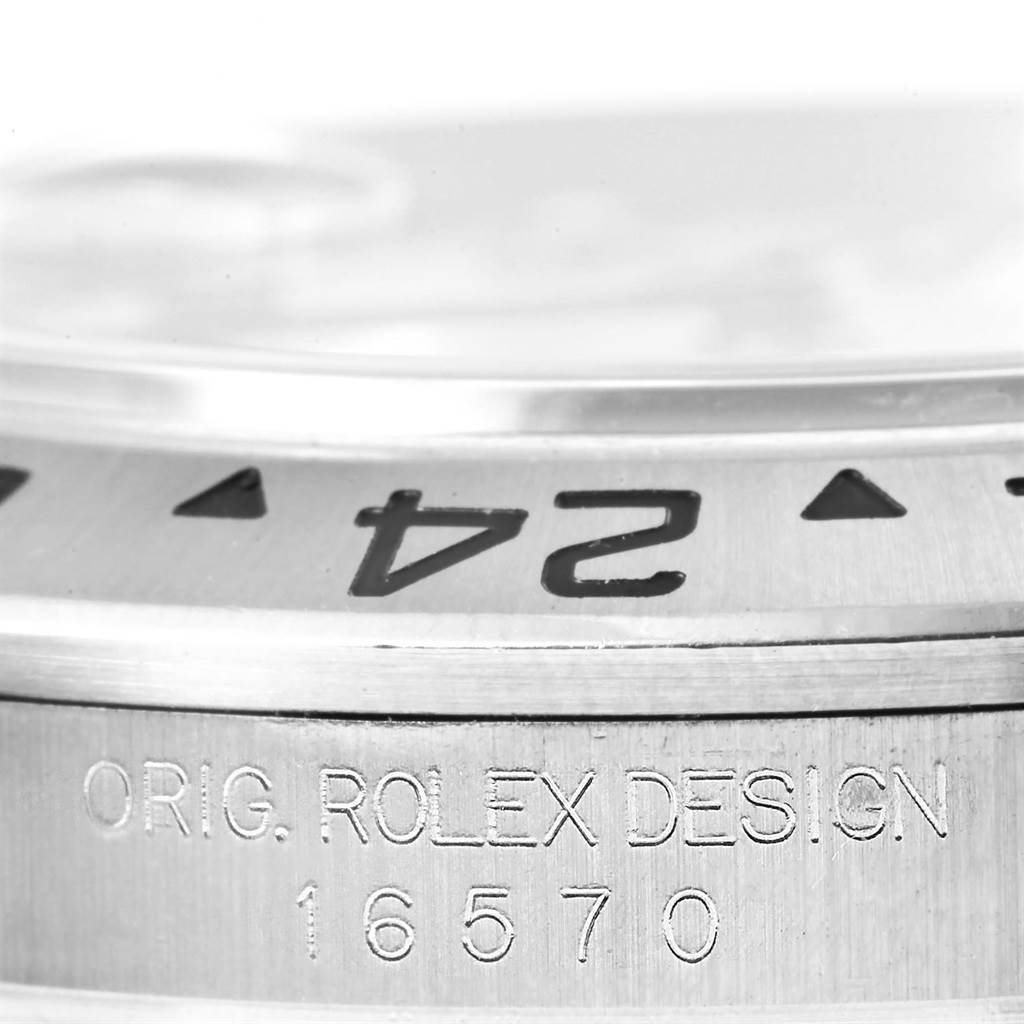 The image shows a close-up of the bezel and serial number engraving on the side of a Rolex Explorer 16570 Men's Stainless Steel White Dial 16570 Men's Stainless Steel White Dial model watch.