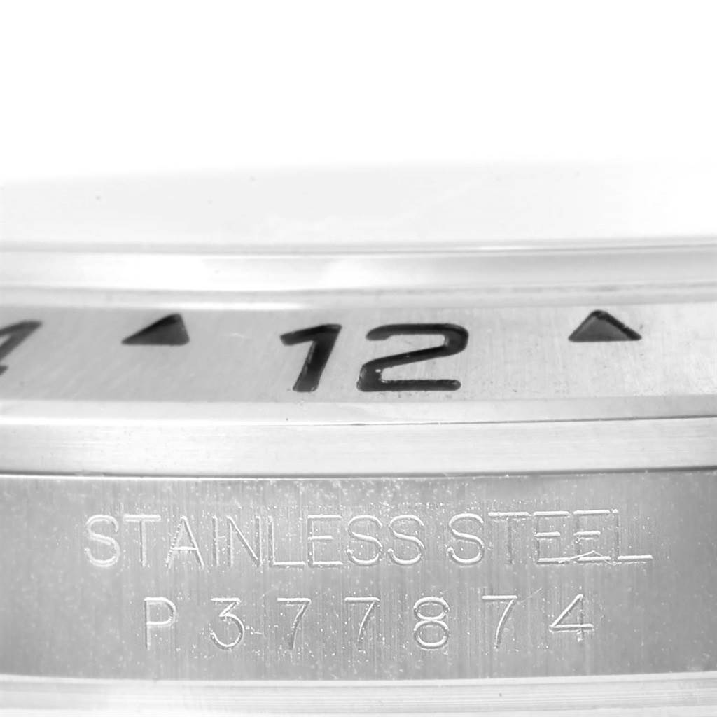 This image shows a close-up angle of the bezel and case side of a Rolex Explorer 16570 Men's Stainless Steel White Dial 16570 Men's Stainless Steel White Dial watch, highlighting the "STAINLESS STEEL" engraving and partial numerals.