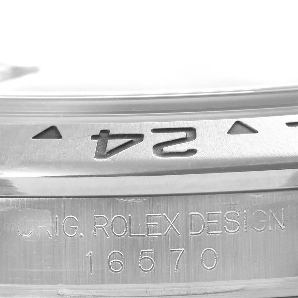 Close-up of a Rolex Explorer 16570 Men's Stainless Steel Black Dial 16570 Men's Stainless Steel Black Dial model 16570 showing the bezel with 24-hour markers and engraved brand name.