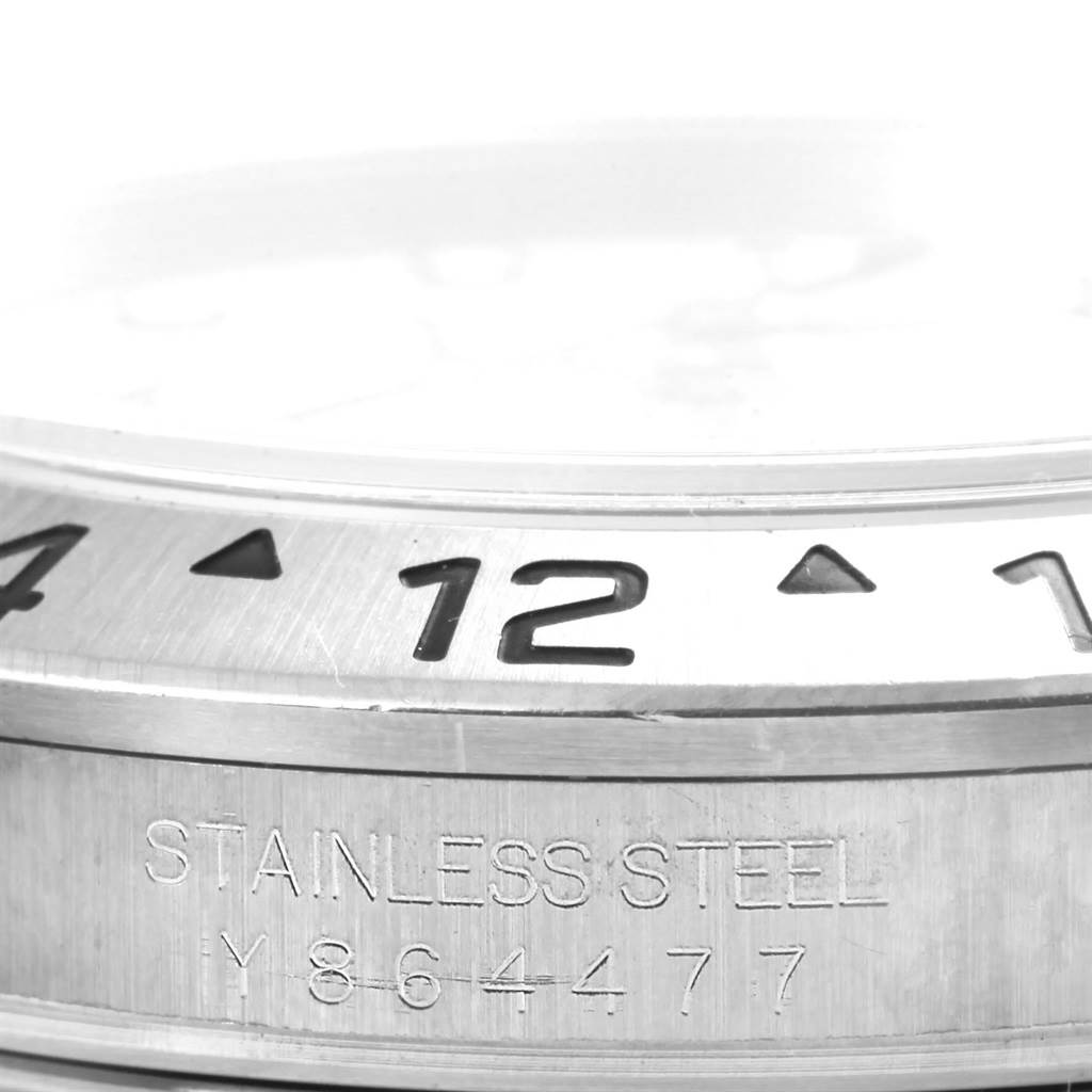 The image shows a close-up of the bezel and side engraving of a Rolex Explorer 16570 Men's Stainless Steel White Dial 16570 Men's Stainless Steel White Dial model watch, highlighting the stainless steel material.