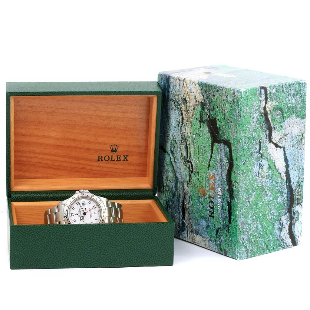 The image shows a Rolex Explorer 16570 Men's Stainless Steel White Dial 16570 Men's Stainless Steel White Dial model watch placed inside its green and wooden box, with the outer box beside it.