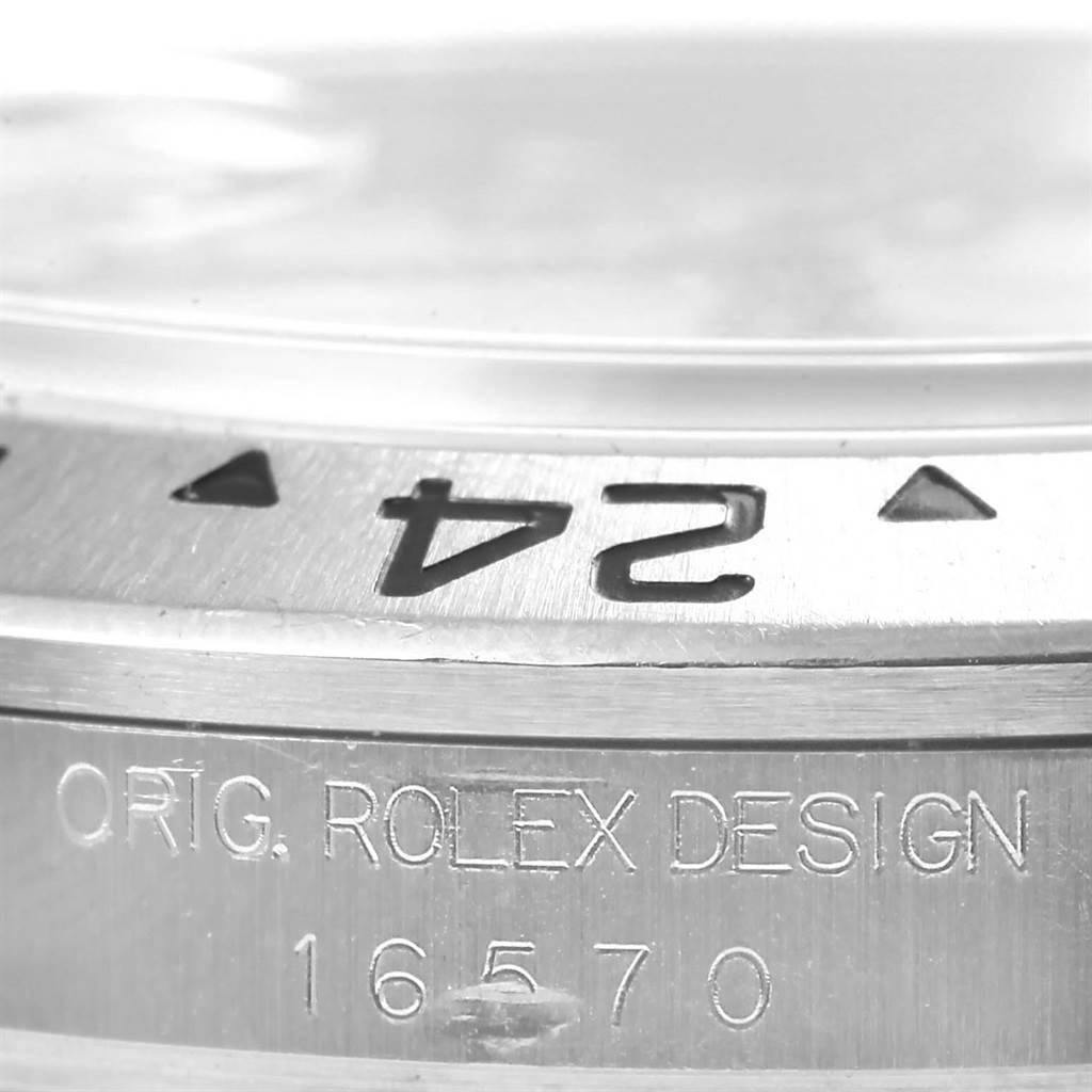 This close-up image features the bezel and serial number of a Rolex Explorer 16570 Men's Stainless Steel White Dial 16570 Men's Stainless Steel White Dial watch, highlighting the "ORIG. ROLEX DESIGN" engraving.