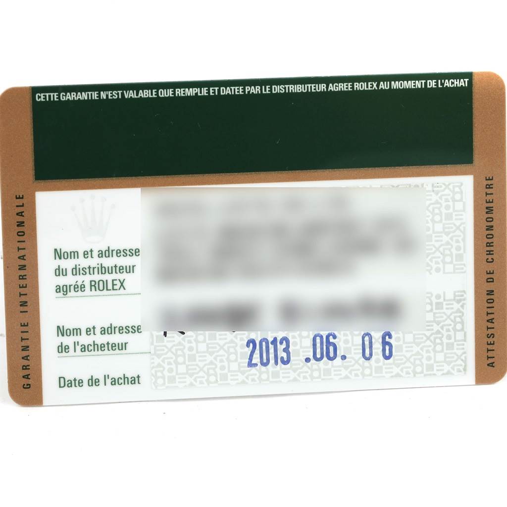 This is a photo of an international warranty card for a Rolex Explorer 114060 Men's Stainless Steel Black Dial 114060 Men's Stainless Steel Black Dial watch, showing the purchase date and partially blurred buyer details.