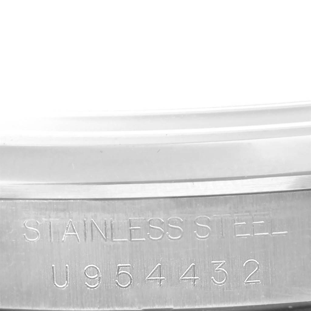 The image shows a close-up view of the serial number and "STAINLESS STEEL" engraving on the side of a Rolex Explorer 14270 Men's Stainless Steel Black Dial 14270 Men's Stainless Steel Black Dial watch.