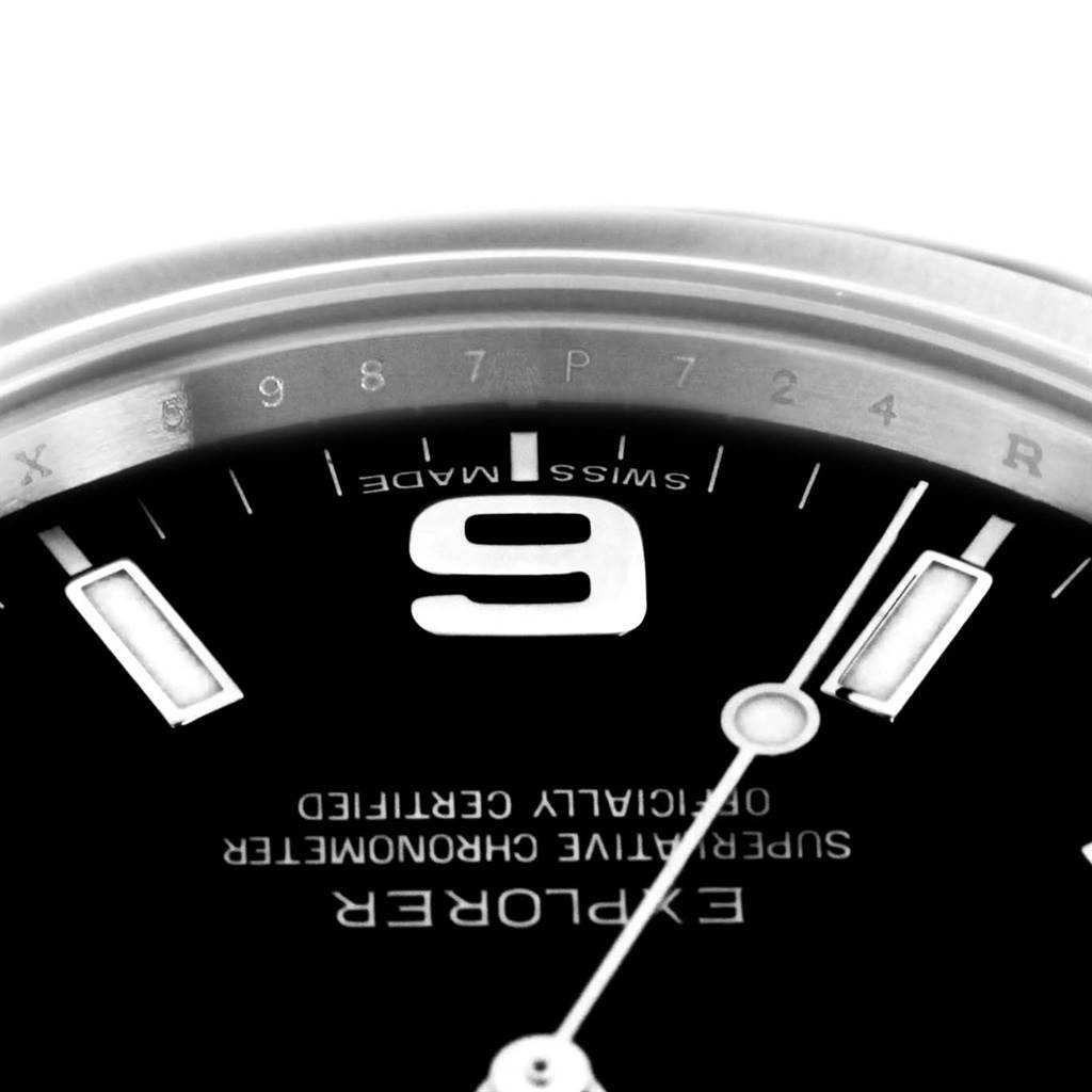 The image shows a close-up of the 9 o'clock marker, part of the dial, and the chapter ring of the Rolex Explorer 214270 Men's Stainless Steel Black Dial 214270 Men's Stainless Steel Black Dial watch.