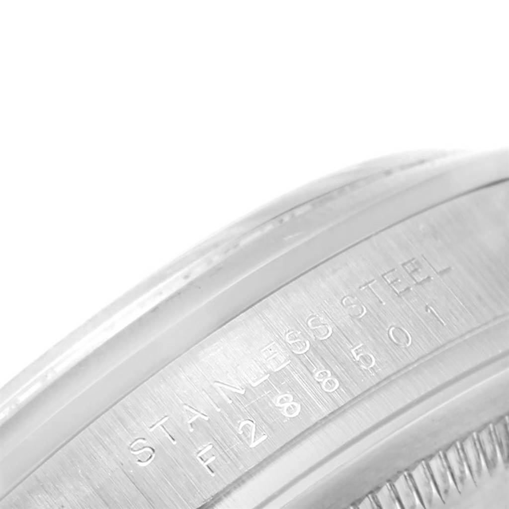 This close-up image shows the side of the stainless steel casing with serial engravings on a Rolex Explorer 114270 Men's Stainless Steel Black Dial 114270 Men's Stainless Steel Black Dial watch.