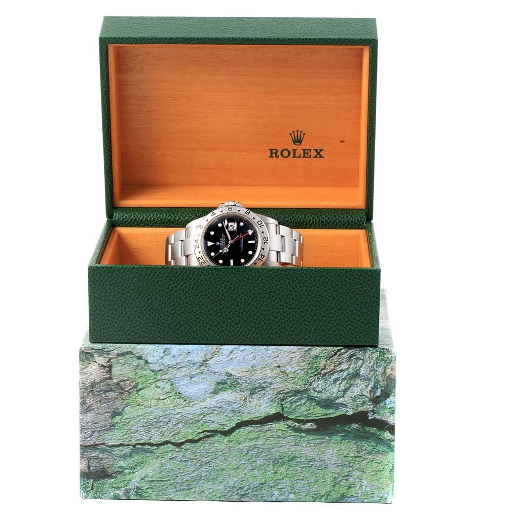 The Rolex Explorer 16570 Men's Stainless Steel Black Dial 16570 Men's Stainless Steel Black Dial watch is displayed front-facing inside an open green and wooden Rolex box.
