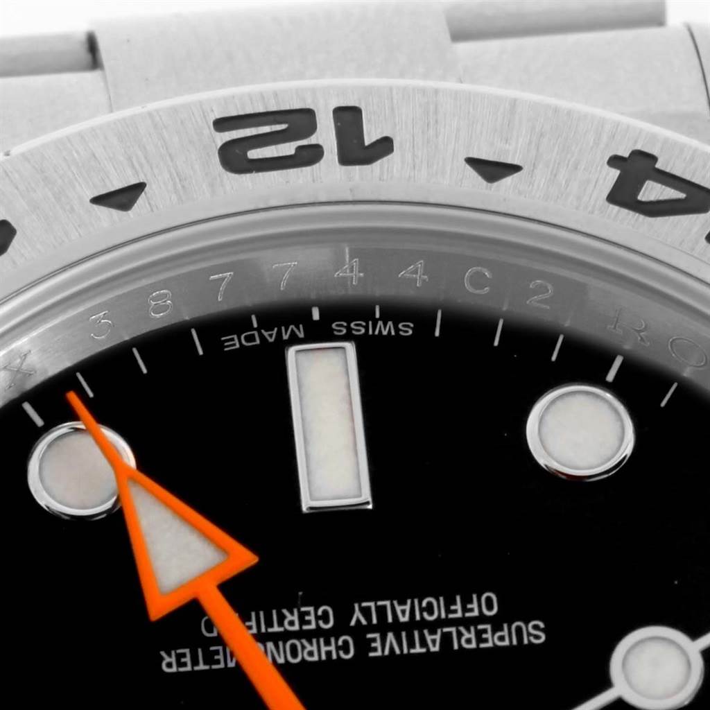 This close-up angle of the Rolex Explorer 216570 Men
s Stainless Steel Black Dial 216570 Men
s Stainless Steel Black Dial watch shows its dial, orange hand, and part of the bezel with engraved numerals.