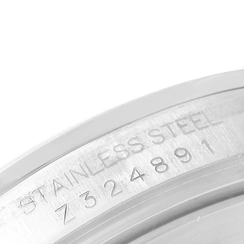 The image shows a close-up of the case back of the Rolex Explorer 16570 Men's Stainless Steel Black Dial 16570 Men's Stainless Steel Black Dial watch, highlighting the stainless steel material and serial number.