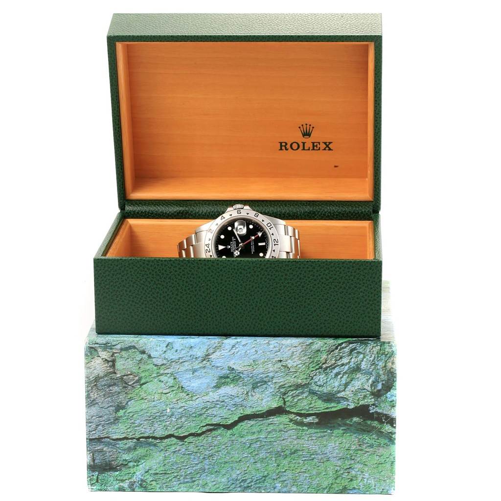 A Rolex Explorer 16570 Men's Stainless Steel Black Dial 16570 Men's Stainless Steel Black Dial watch is shown at a front angle, sitting inside its open green and wood watch box.