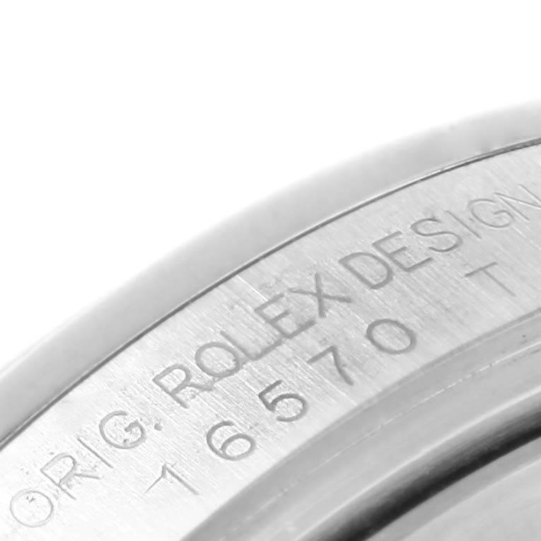 The image shows an angled close-up of the case side of a Rolex Explorer 16570 Men's Stainless Steel Black Dial 16570 Men's Stainless Steel Black Dial watch, displaying the "ROLEX DESIGN" engraving and model number.