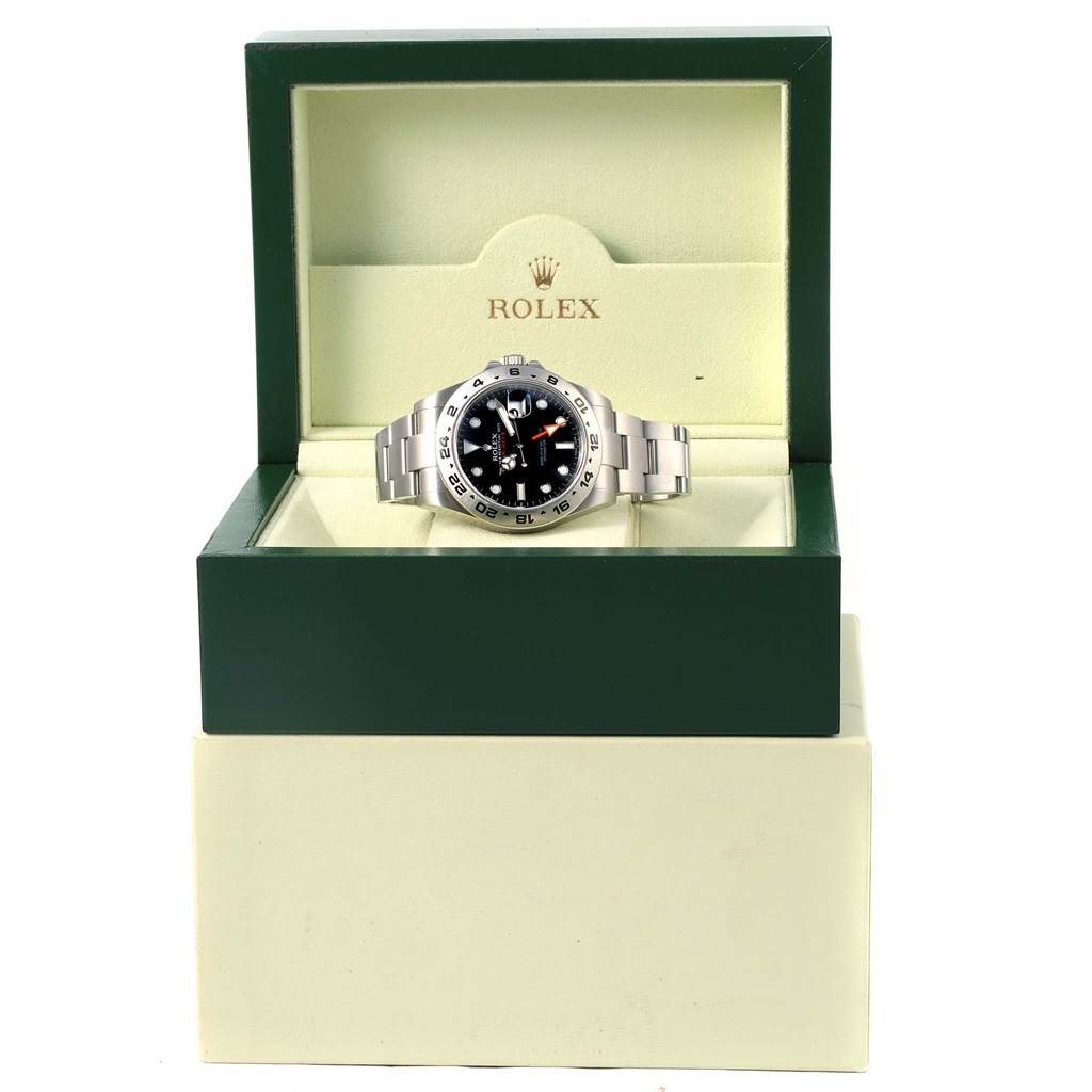 The Rolex Explorer 216570 Men's Stainless Steel Black Dial 216570 Men's Stainless Steel Black Dial watch is displayed from the front in an open green and beige Rolex box.