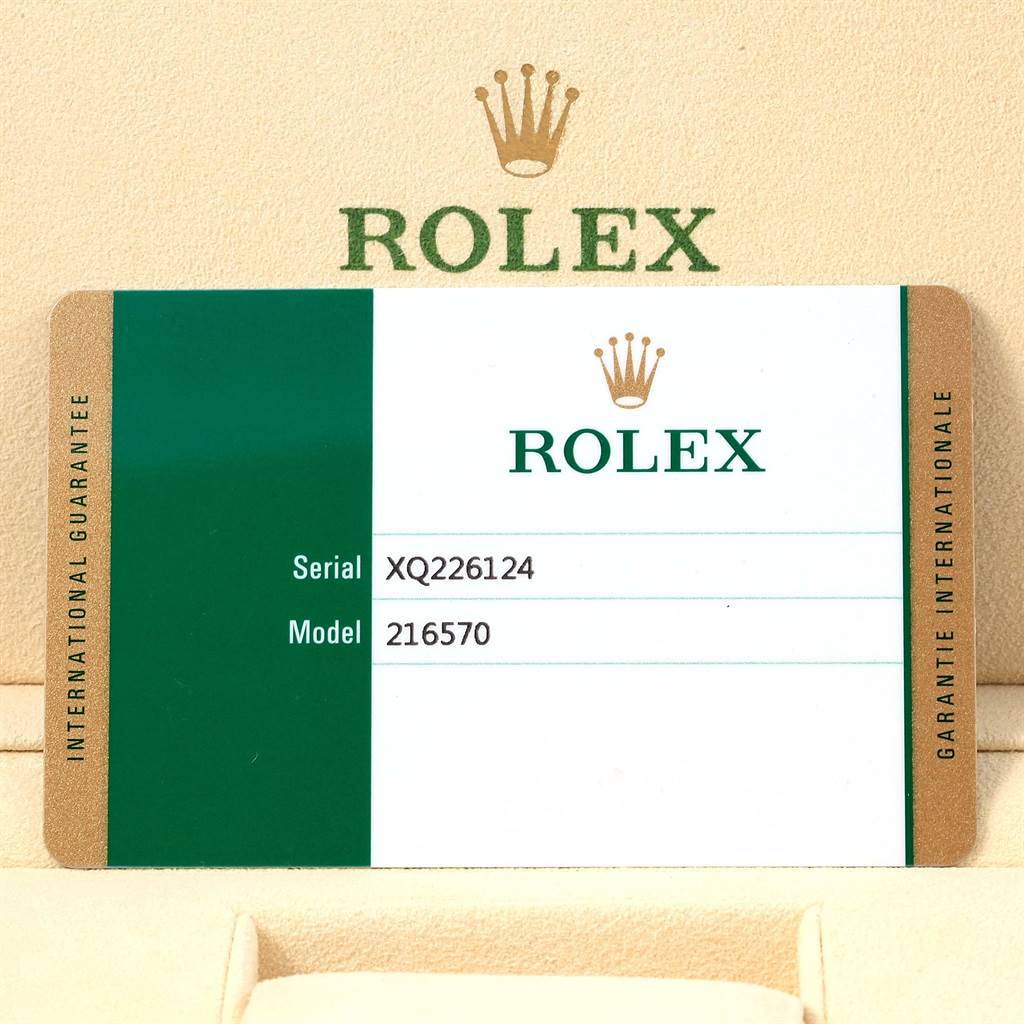 The image shows a warranty card for a Rolex Explorer 216570 Men's Stainless Steel White Dial 216570 Men's Stainless Steel White Dial model 216570, displaying the serial number and brand logo.