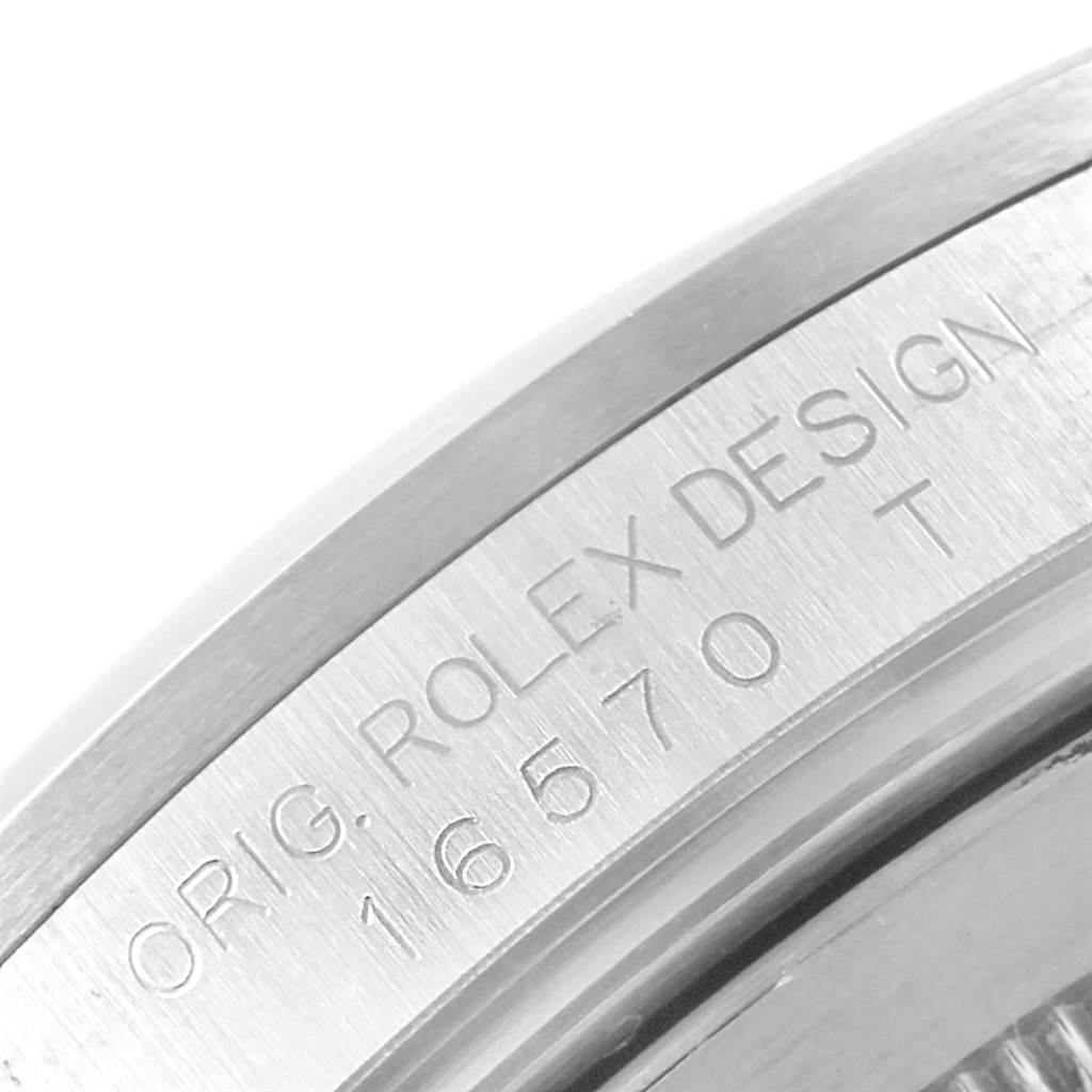 This close-up image shows the engraved reference number and design inscription on the case side of a Rolex Explorer 16570 Men's Stainless Steel White Dial 16570 Men's Stainless Steel White Dial model.