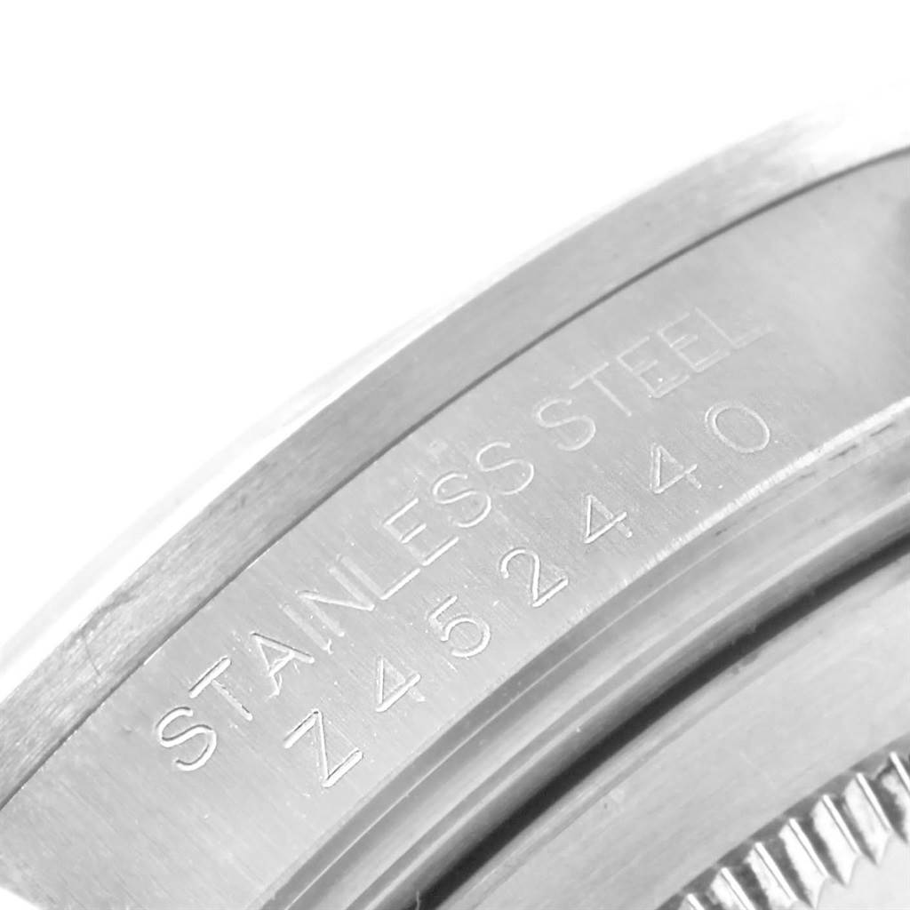 The image shows a close-up of the casing edge with the serial numbers engraved on a Rolex Explorer 16570 Men's Stainless Steel White Dial 16570 Men's Stainless Steel White Dial watch.