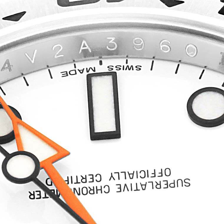 Close-up shot of the Rolex Explorer 216570 Men's Stainless Steel White Dial 216570 Men's Stainless Steel White Dial watch showing part of the dial with hour markers and the "Swiss Made" inscription.