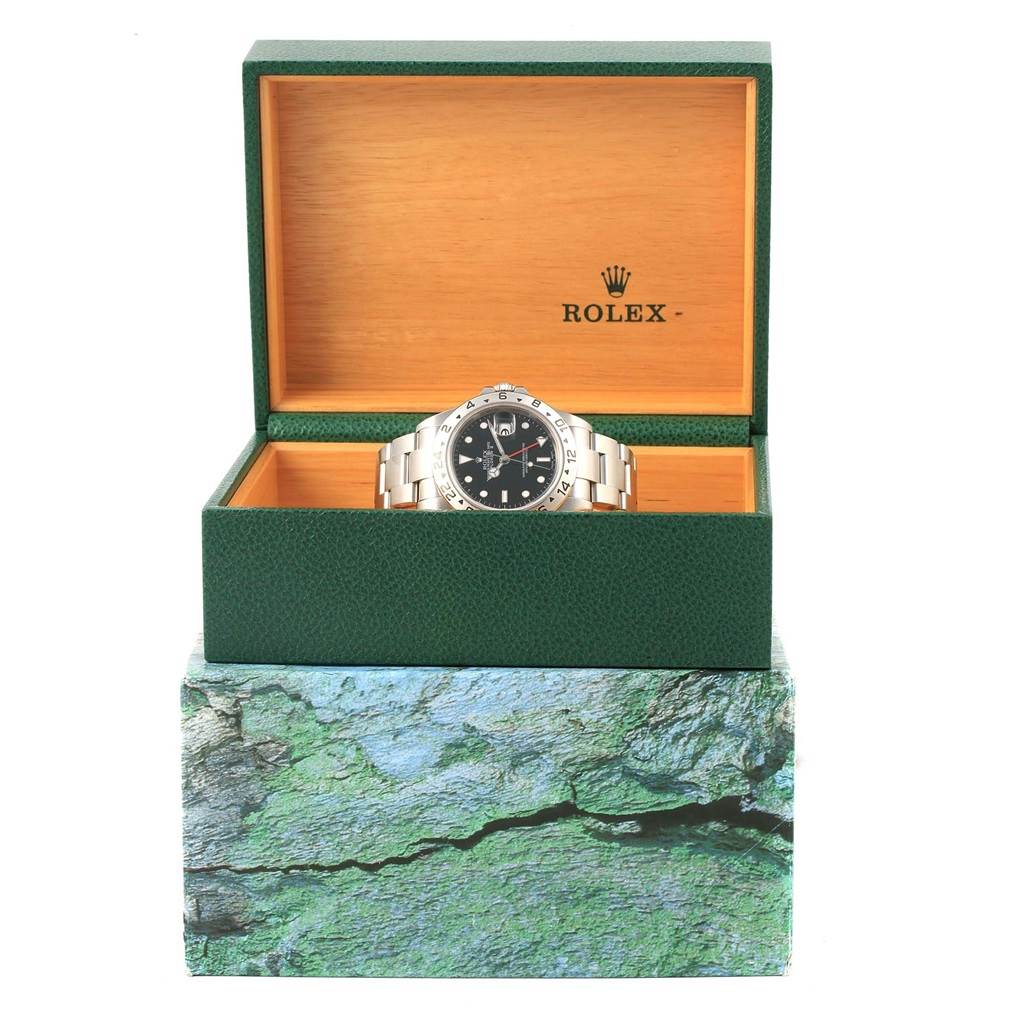 The Rolex Explorer 16570 Men's Stainless Steel Black Dial 16570 Men's Stainless Steel Black Dial watch is displayed in its open green and wood box, showing the face and bracelet.
