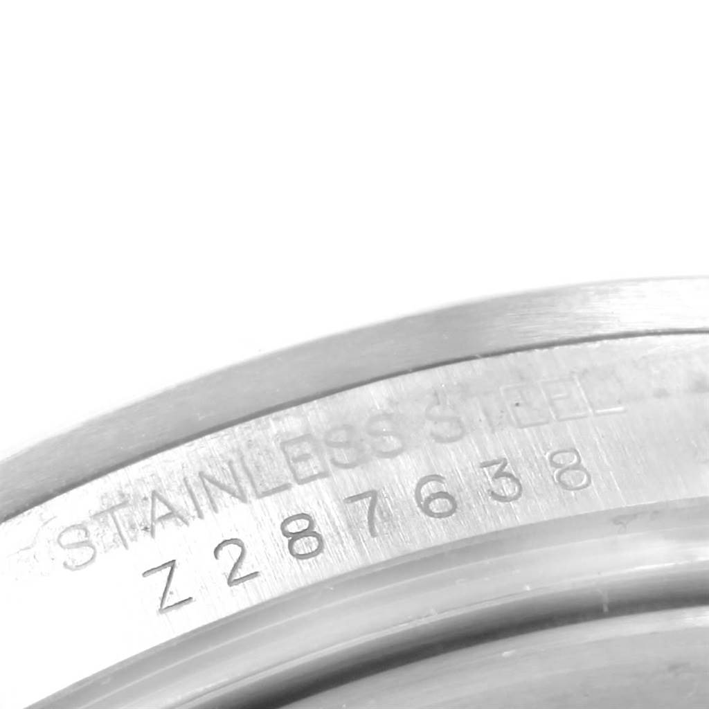 This image shows a close-up of the serial number and "Stainless Steel" engraving on a Rolex Explorer 16570 Men's Stainless Steel Black Dial 16570 Men's Stainless Steel Black Dial watch.