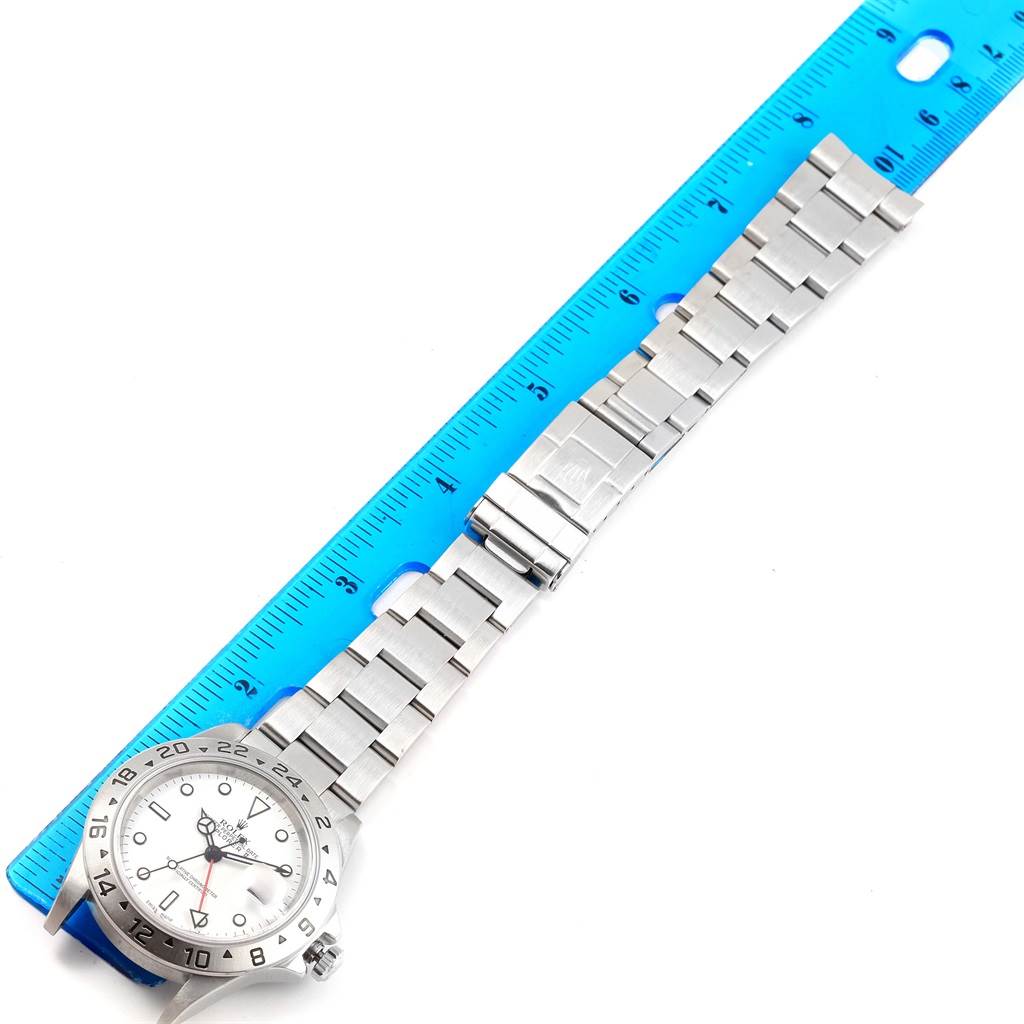 The image shows a Rolex Explorer 16570 Men's Stainless Steel White Dial 16570 Men's Stainless Steel White Dial watch laid flat with the full bracelet and face visible, alongside a ruler for size reference.