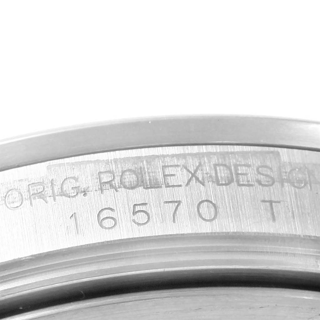 The image shows a close-up of the engraved inner bezel of a Rolex Explorer 16570 Men's Stainless Steel White Dial 16570 Men's Stainless Steel White Dial watch, detailing the model number 16570.