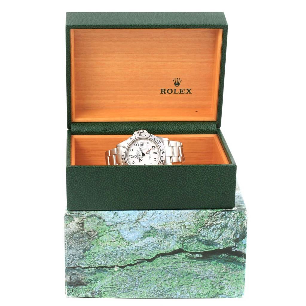 The image shows a Rolex Explorer 16570 Men's Stainless Steel White Dial 16570 Men's Stainless Steel White Dial watch in its open green and wooden box from a front angle.