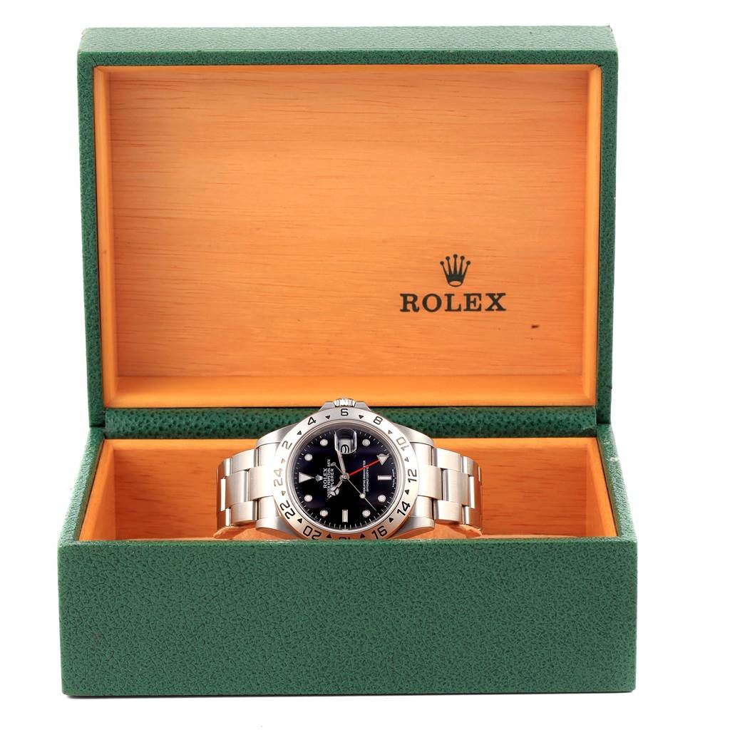The image shows a Rolex Explorer 16570 Men's Stainless Steel Black Dial 16570 Men's Stainless Steel Black Dial watch in a green and orange Rolex box, with the face, bezel, and bracelet visible.