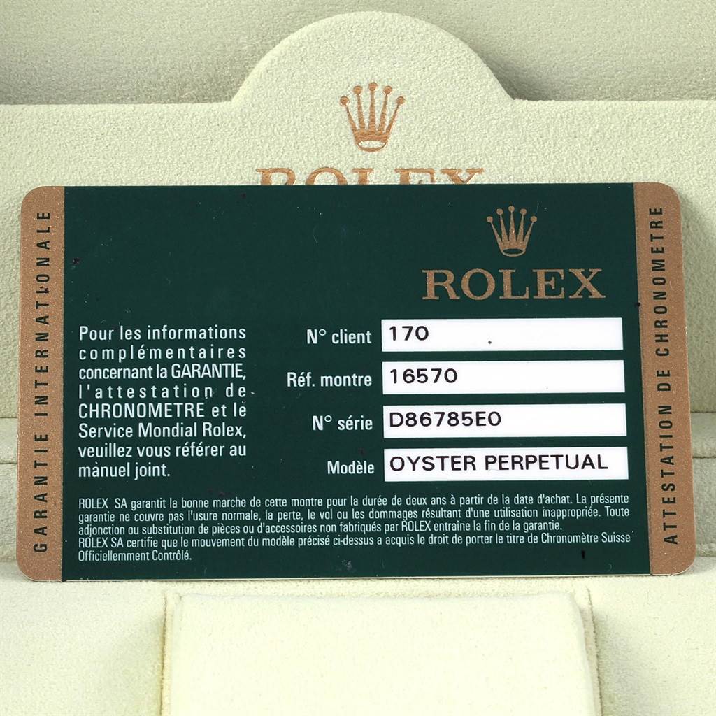 The image shows the warranty card for a Rolex Explorer 16570 Men's Stainless Steel White Dial 16570 Men's Stainless Steel White Dial model watch placed against a branded case.
