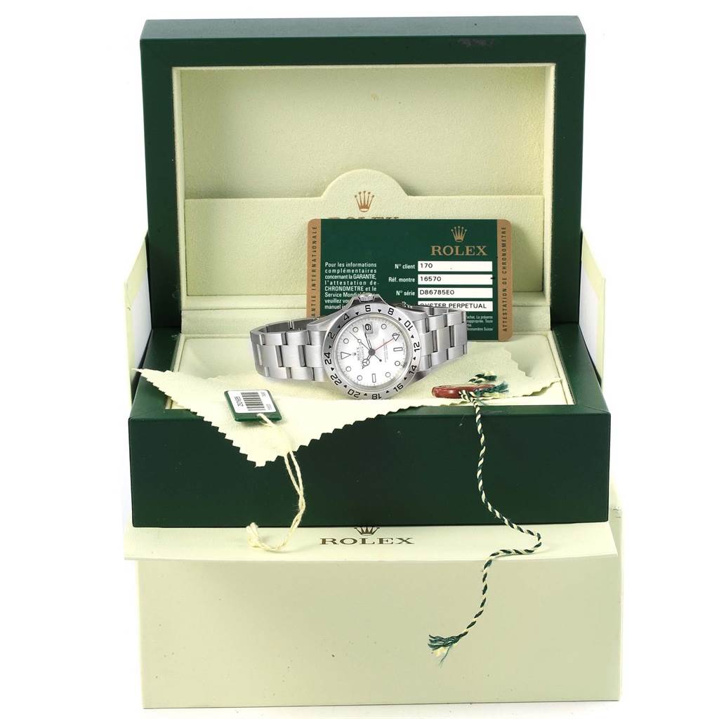 The Rolex Explorer 16570 Men's Stainless Steel White Dial 16570 Men's Stainless Steel White Dial watch is shown in an open box with its guarantee card and tags, viewed from a front angle.
