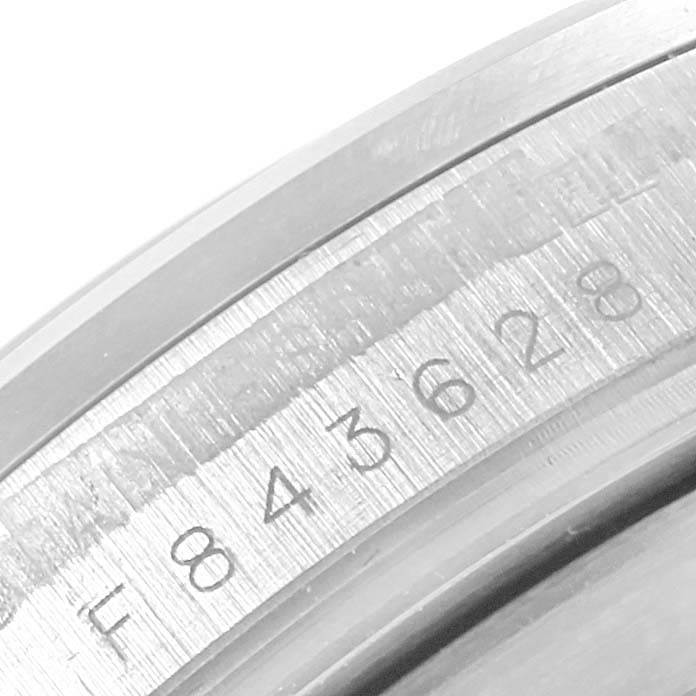 This close-up image shows the serial number engraving on the side of the Rolex Explorer 16570 Men's Stainless Steel White Dial 16570 Men's Stainless Steel White Dial watch case.