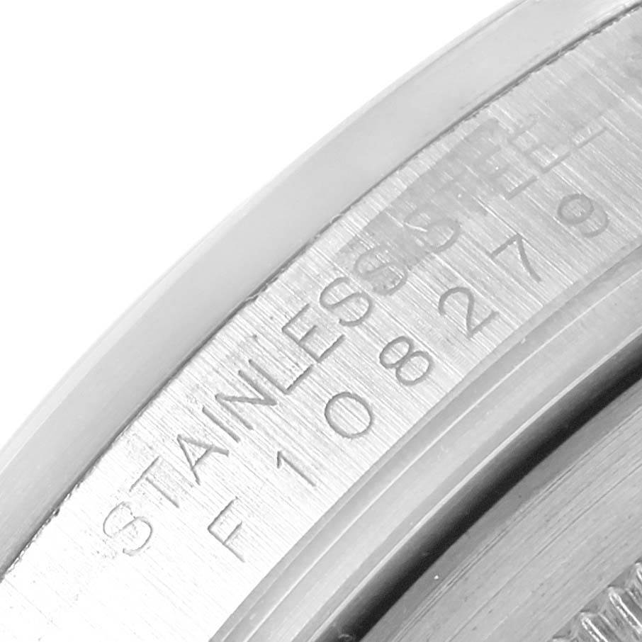 The image shows a close-up of the serial number and "STAINLESS STEEL" engraving on the side of the bezel of a Rolex Explorer 16570 Men's Stainless Steel White Dial 16570 Men's Stainless Steel White Dial watch.