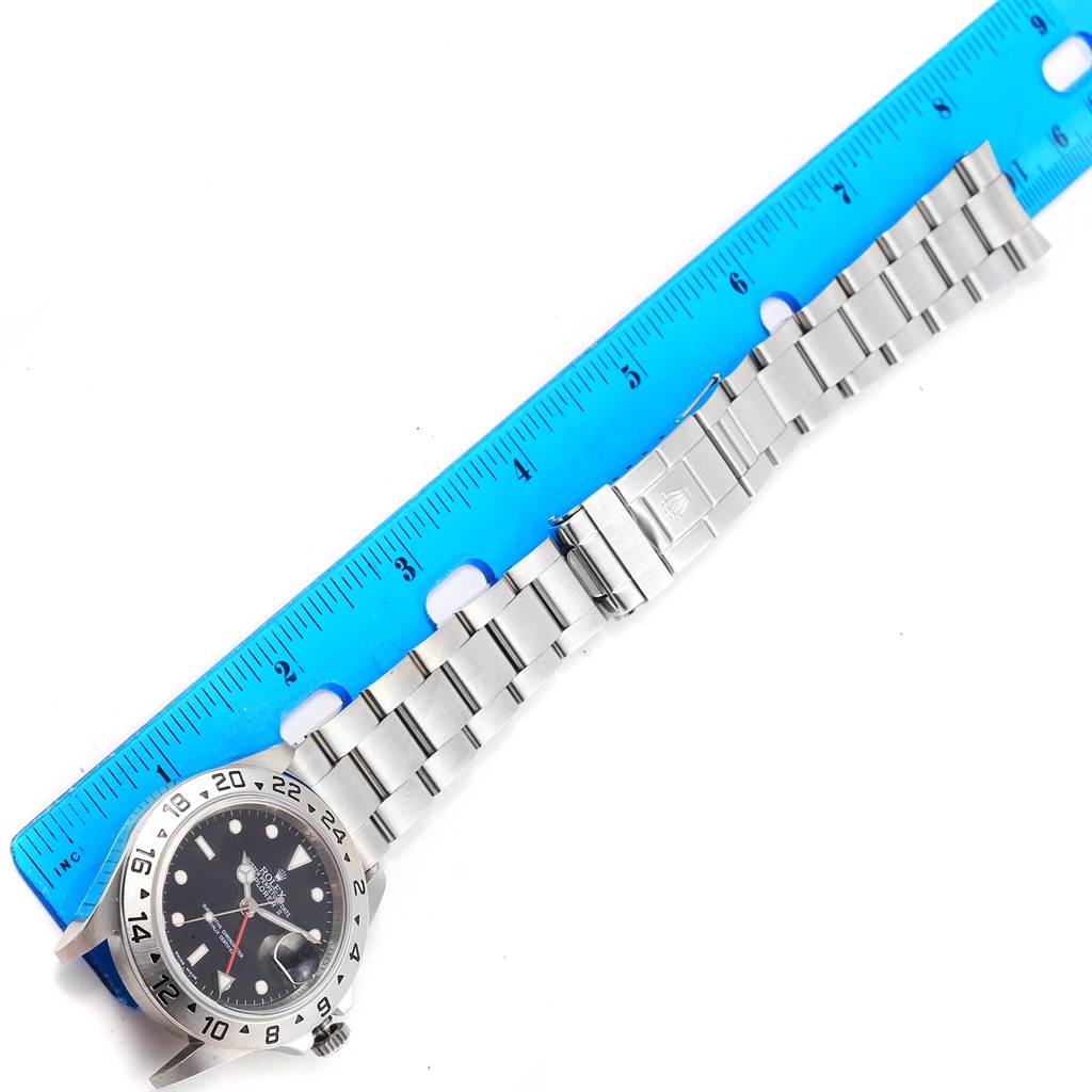 The image shows a Rolex Explorer 16570 Men's Stainless Steel Black Dial 16570 Men's Stainless Steel Black Dial watch laid flat with a blue ruler measuring its length.