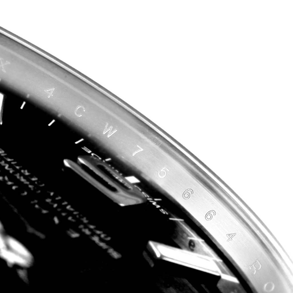 The image shows a close-up of the edge of a Rolex Explorer 214270 Men's Stainless Steel Black Dial 214270 Men's Stainless Steel Black Dial watch with visible engravings on the bezel.
