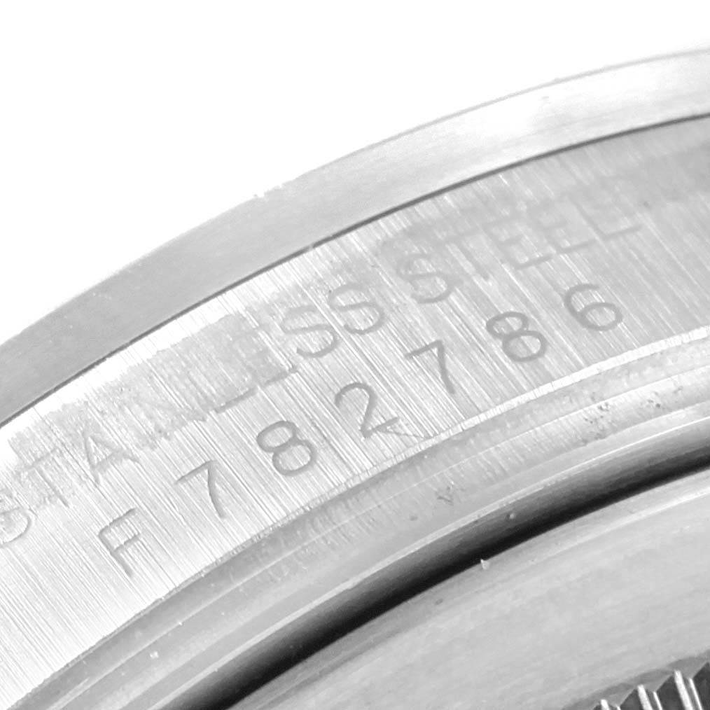 The image shows a close-up of the case back and engravings of a Rolex Explorer 16570 Men's Stainless Steel Black Dial 16570 Men's Stainless Steel Black Dial watch, highlighting the serial and model numbers.