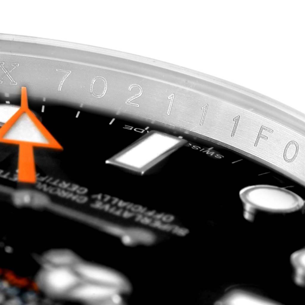 The image shows a close-up of the dial and serial number on the bezel of a Rolex Explorer 216570 Men's Stainless Steel Black Dial 216570 Men's Stainless Steel Black Dial watch.