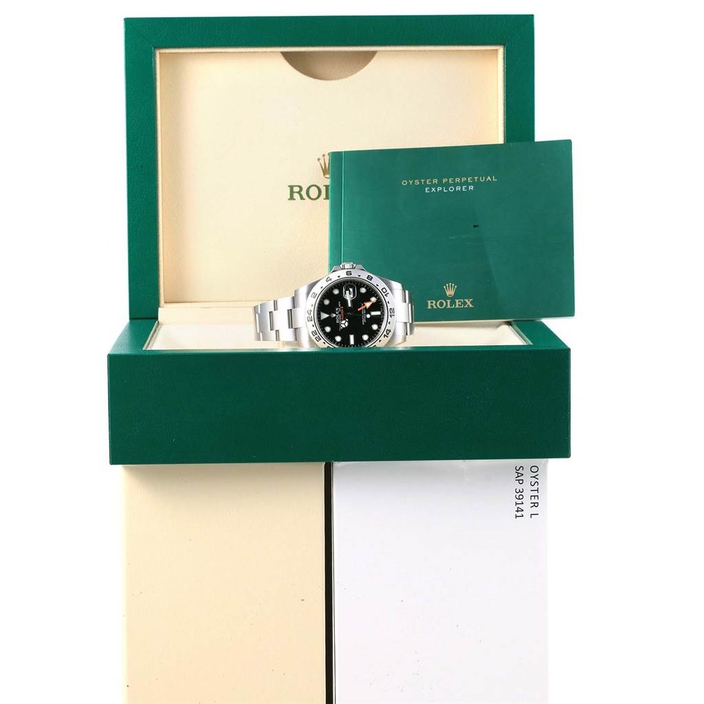 The image shows a Rolex Explorer 216570 Men's Stainless Steel Black Dial 216570 Men's Stainless Steel Black Dial watch with its stainless steel bracelet, presented in an open box with accompanying documentation.