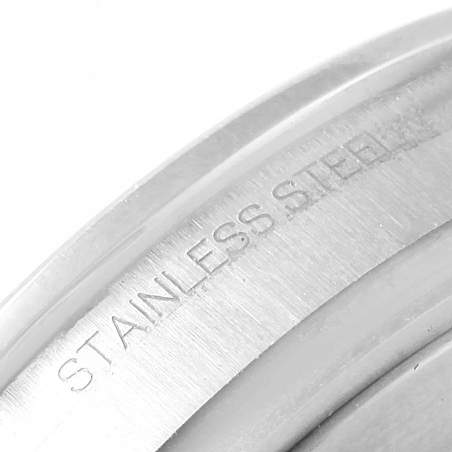 The image shows a close-up angle of the stainless steel case back of the Rolex Explorer 216570 Men's Stainless Steel White Dial 216570 Men's Stainless Steel White Dial model watch.