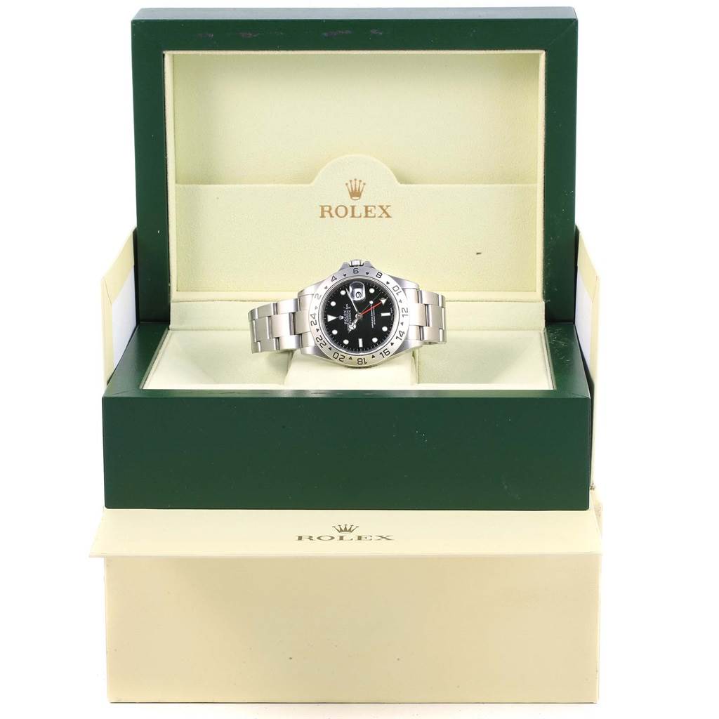 The image shows a Rolex Explorer 16570 Men's Stainless Steel Black Dial 16570 Men's Stainless Steel Black Dial watch front-on, inside its open green and cream Rolex box.