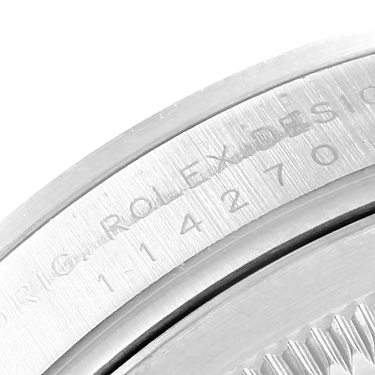 This close-up image shows the engraved inner bezel of a Rolex Explorer 114270 Men's Stainless Steel Black Dial 114270 Men's Stainless Steel Black Dial watch.